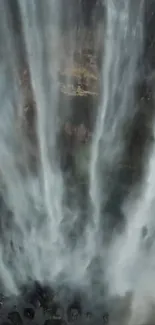 Vertical view of a majestic cascading waterfall.