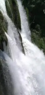 Cascading waterfall with lush greenery in a serene natural setting.