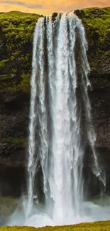 Cascading waterfall against a vibrant sunset sky.