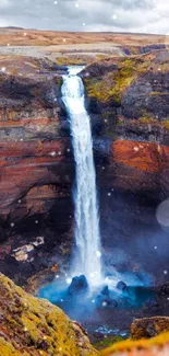 Majestic waterfall in a scenic landscape with a blue pool.