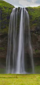 Majestic waterfall over lush green cliffs in serene mobile wallpaper.