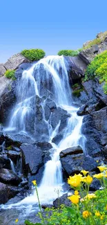 Scenic waterfall with rocks, greenery, and blue sky.