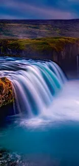 Vibrant waterfall cascading in lush landscape wallpaper.