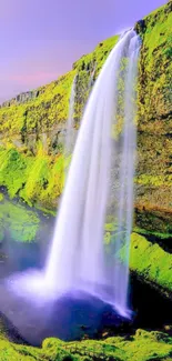 Majestic waterfall with lush green landscape under a pink-hued sky.