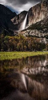 Waterfall cascading down mountain, reflecting in calm water.