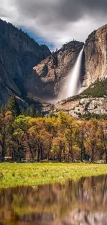 Majestic waterfall flowing down a mountain into a serene lake.