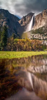 Majestic waterfall on mountain with forest and lake reflection.