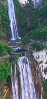 Vertical waterfall cascades over lush green cliffs.