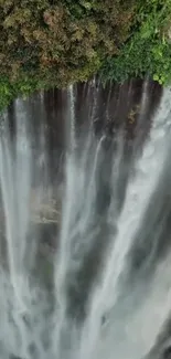 A stunning waterfall surrounded by lush greenery cascading down into serene waters.