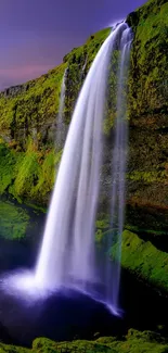 Lush waterfall cascading over green cliffs under a purple sky.