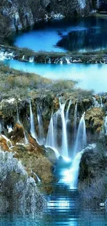 Blue cascading waterfall surrounded by nature.