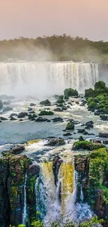 Panoramic view of a lush waterfall with greenery and sky.