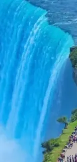 Vibrant turquoise waterfall with lush greenery.