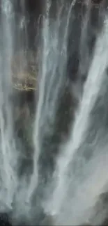 Waterfall cascading down rocks in serene nature scene.