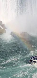 Cruise boat under a rainbow near a waterfall.