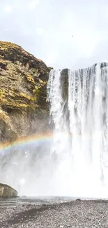 Majestic waterfall with vibrant rainbow scene.