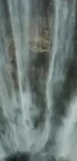 A dramatic vertical view of a waterfall, with cascading water creating a serene atmosphere.