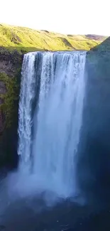 Beautiful waterfall cascading over a cliff with vibrant greenery.