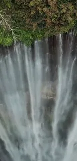 A breathtaking waterfall cascading down surrounded by lush greenery.