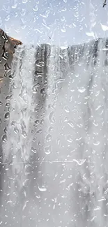 Waterfall with raindrops on a cool, gray backdrop for phones.