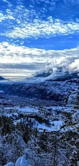 Snowy mountain vista with blue sky and clouds.