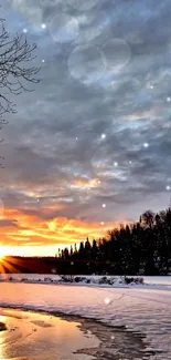 Winter sunset scene with snow, trees, and a serene river reflecting the vibrant sky.