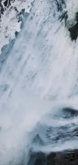 Dynamic waterfall with surrounding ice in a winter landscape.