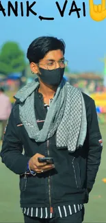 Young man in scarf and mask standing stylishly outdoors.