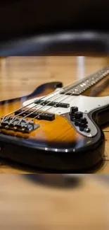 Close-up of a stylish bass guitar on wooden floor.