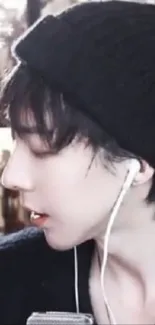 Person wearing a black beanie and earbuds in a stylish side profile view.