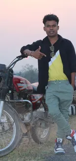 Trendy man in casual outfit with motorcycle in countryside.