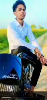 Man sitting on a motorcycle; scenic countryside backdrop