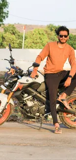 Man sitting on a stylish motorcycle in an outdoor setting.