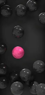 Black spheres with a unique pink sphere in the center.