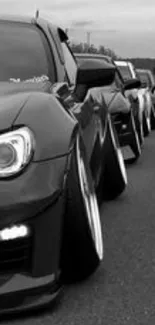 Black and white lined-up luxury vehicles wallpaper.