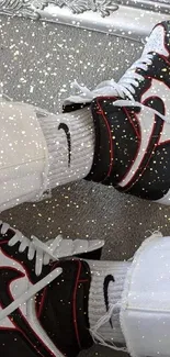 Black and white sneakers with red accents in mirror reflection.