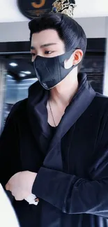 Mobile wallpaper featuring a masked figure in black attire.