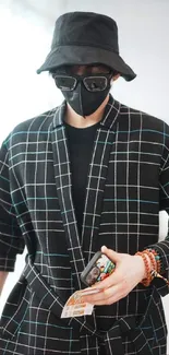 Mysterious figure in a black plaid outfit and mask.