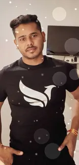 Man wearing a stylish black graphic t-shirt in modern interior.