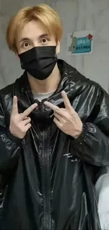 Casual portrait of person wearing black mask and jacket.