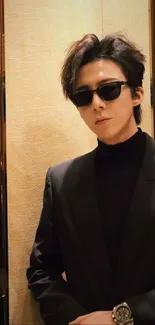 Man in black suit with sunglasses, stylish wallpaper.