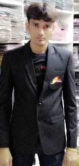 Man in a sleek black suit standing in a clothing store.
