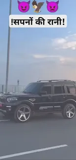 Black SUV driving on the road at sunset.
