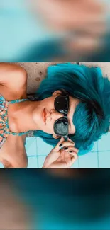 Woman with blue hair and sunglasses by the pool.