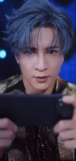 Blue-haired gamer holding a phone, set as vibrant mobile wallpaper.