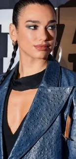 Model wearing a blue leather jacket on a stylish backdrop