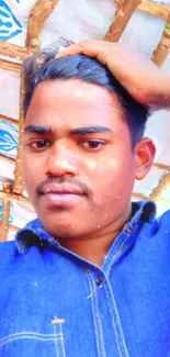 Person in a blue shirt under rustic roof.