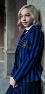 Person in blue striped suit leaning against a wall.