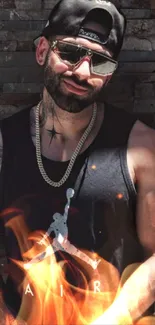 Man in cap and sleeveless shirt against brick wall.