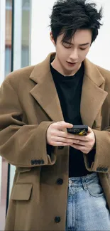 Person in a brown coat using a phone.